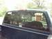 1995 GMC Sierra 1500 - Reflection in the rear window shows a garage and another vehicle.