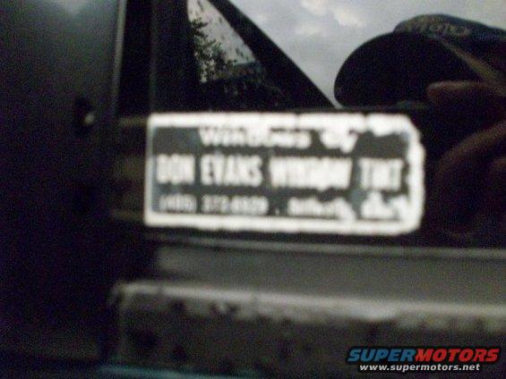 Sticker on dark vehicle door reads "DON EVANS WINDOW TINT" with phone number