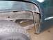1995 GMC Sierra 1500 - Close-up of the rear wheel well area on a 1995 GMC Sierra 1500, showing the exhaust pipe and leaf spring.