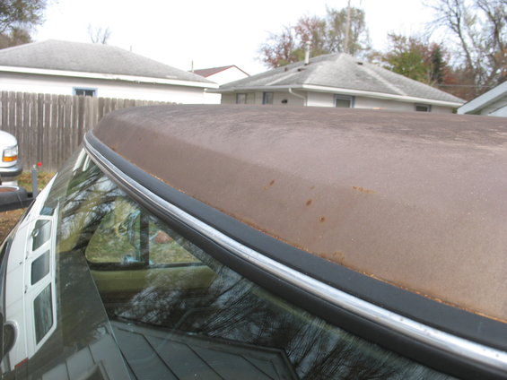 Rusted brown truck roof with chrome trim