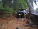 1989 Ford Bronco - Ford Bronco tackling a challenging off-road course through a wooded area.
