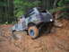 1989 Ford Bronco - Ford Bronco tackling a challenging off-road course, with mud and rocks on the trail.