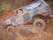 1989 Ford Bronco - A driver navigates a off-road course in a camouflage Ford Bronco, tackling challenging terrain.
