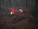 1989 Ford Bronco - Red 1989 Ford Bronco struggling through deep mud on a forest trail.