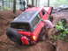1989 Ford Bronco - A red SUV navigates a muddy off-road trail with assistance from onlookers.