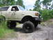 1989 Ford Bronco - This lifted 1989 Ford Bronco navigates a muddy off-road path, its capabilities.
