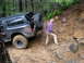1979 Ford Bronco - A black SUV navigates a challenging muddy off-road course.
