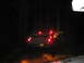 1979 Ford Bronco - Vehicles navigate a dark, wooded area at night, with the lead vehicle's brake lights illuminating the path.