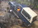 1979 Ford Bronco - This 1979 Ford Bronco tackles a challenging off-road course, demonstrating its capabilities on a wet and muddy terrain.