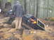 1979 Ford Bronco - Two people are near a vehicle that is stuck in the mud in a wooded area.