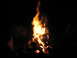 1979 Ford Bronco - A campfire burns brightly in the dark, with logs stacked for fuel.