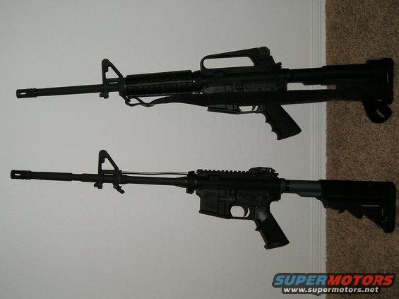 Two black rifles displayed on a wall