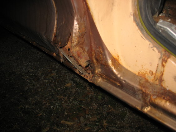 Front of center post on passenger side, rear of front door.
