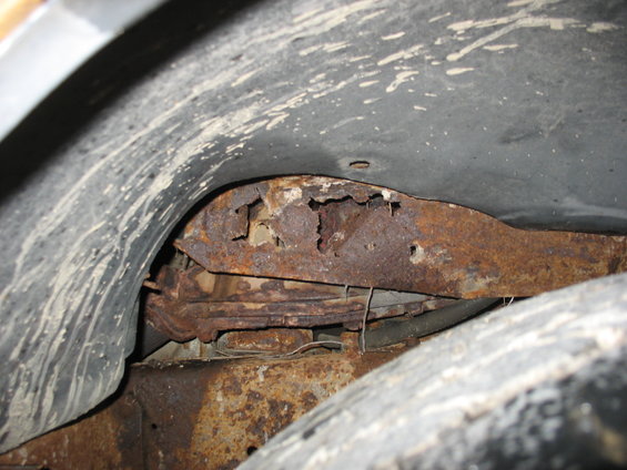 Inside the passenger side front fender well.