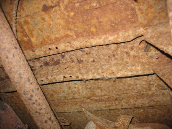 img_0859.jpg Between the frame rails, in front the front fuel tank. Driver's side.