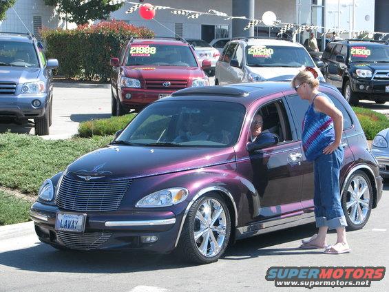 Purple Chrysler PT Cruiser with chrome wheels and custom grille