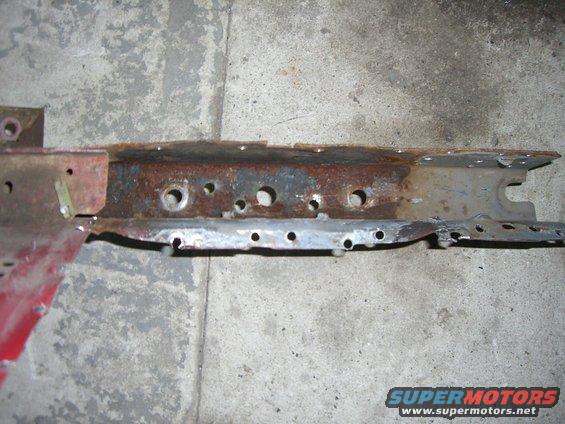rusted metal frame section with multiple holes drilled