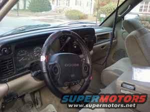 1996 Dodge 1500 interior showing dashboard, steering wheel with Dodge logo, and tan seats