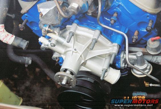 Engine water pump with blue painted engine block and black pulley