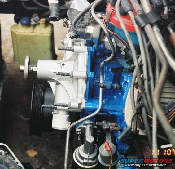 Close-up of a vehicle's engine water pump, painted blue