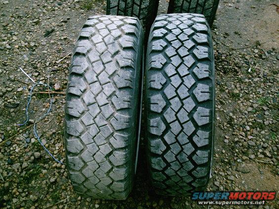 Two off-road tires with aggressive tread patterns