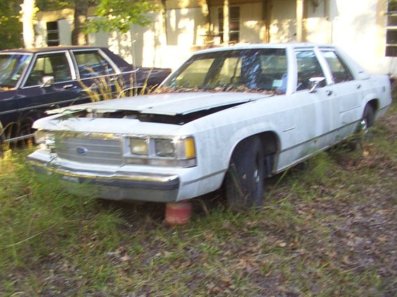 White 1991 Ford Crown Victoria LTD with hood up, parked next to a dark car