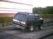 1988 Ford Bronco - This black Ford Bronco is seen from a rear-left angle, equipped with a bike rack on its tailgate.