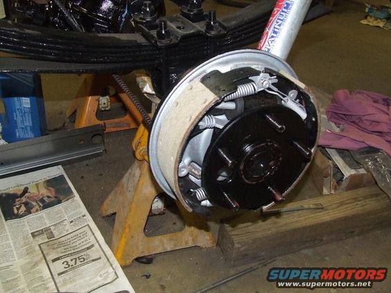 rear drum brake assembly on jack stands, leaf spring above