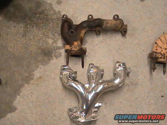 two exhaust manifolds, one rusty and one chrome, on a concrete floor
