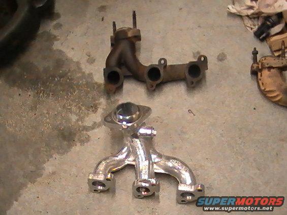 Two exhaust manifolds on a concrete floor; one is rusty, the other is shiny