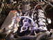 1990 Ford Probe - Close-up view of an engine bay, a chrome intake manifold and distributor cap.