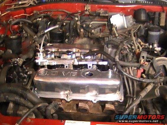 Engine bay with chrome valve cover reading "3.0 VE"