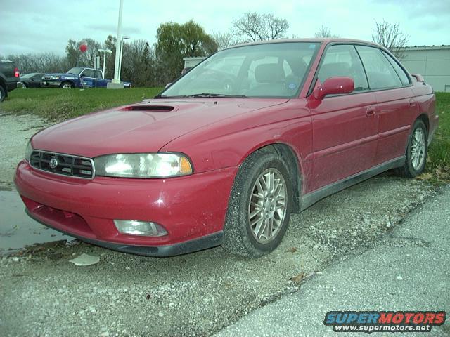 Red 1997 Subaru Legacy sedan, 3/4 front view