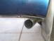 2001 Ford F-350 - Exhaust pipe detail on a blue vehicle, showing the exit point and a mud flap.