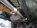 2001 Ford F-350 - The exhaust system and drivetrain components are visible from underneath the truck.