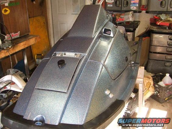 Sparkling blue jet ski front section on a stand, with storage compartment and windshield