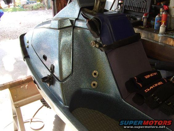 Close-up of a blue glitter jet ski's interior with Dakine gloves on the seat