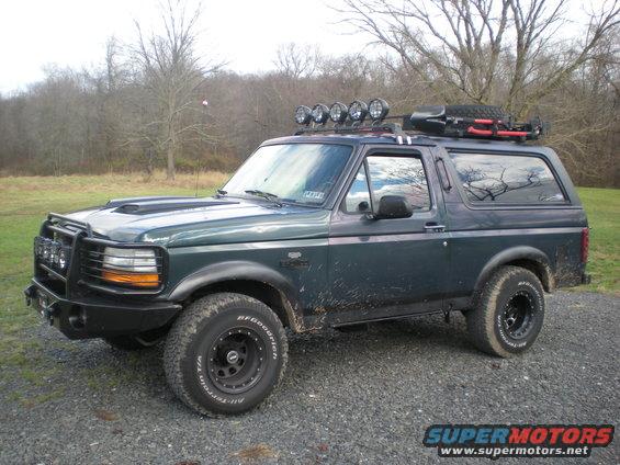 1993 Ford Bronco with roof rack, spare tire, and off-road lights
