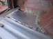1988 Ford Bronco - A close-up view of a patched floor pan in a vehicle undergoing restoration.