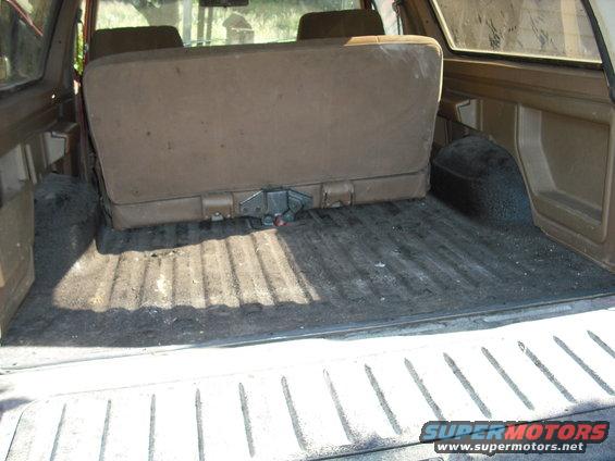 1988 Ford Bronco interior cargo area with folded rear seat and ribbed floor