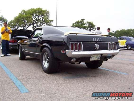 Black 1970 Ford Mustang parked, showing rear end and license plate HSL-106