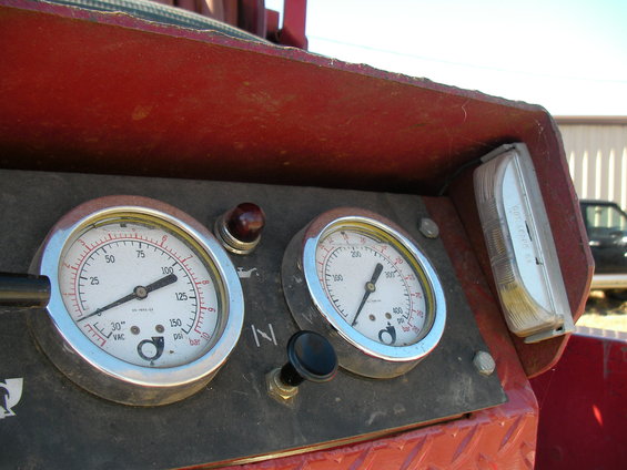 Close-up of a gauge panel with two pressure gauges, one reading 100 PSI and the other around 300 PSI