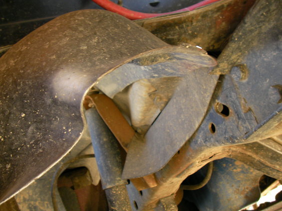 Close-up of a rusty metal suspension component on a vehicle frame