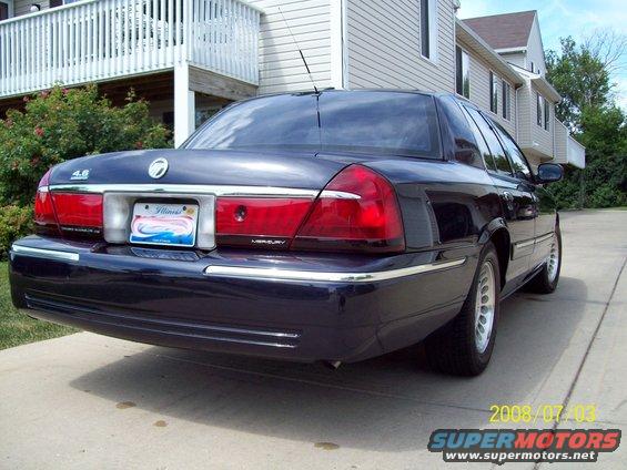 1999 Mercury Grand Marquis rear view, dark blue, parked on concrete driveway