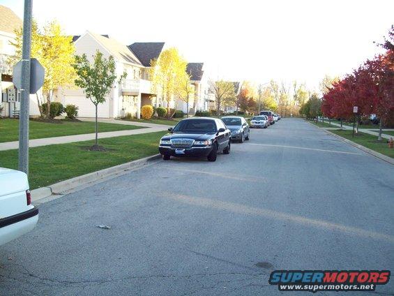 Several cars parked on a suburban street