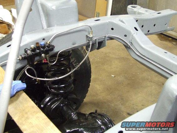 Brake lines and master cylinder on vehicle frame with coil spring suspension