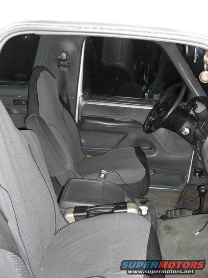 Interior shot of a vehicle showing front seats, dashboard, and steering wheel