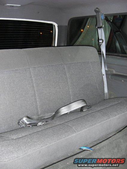 Gray fabric rear bench seat with a black seatbelt in a 1993 Ford Bronco