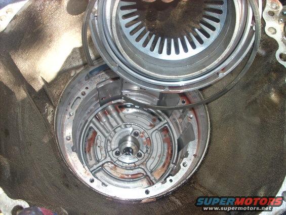remove your jack and remove your center support

i made the mistake of removing the inner ring and this is what happens, the intermediate cylinder springs out of the center support 