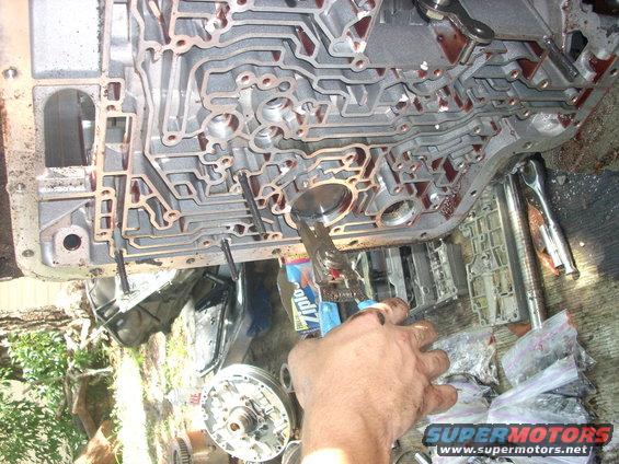 trans26.jpg then you can remove the OD servo, snap ring, and cover

BE CAREFULL! it will fly out of there if you are not holding pressure on it